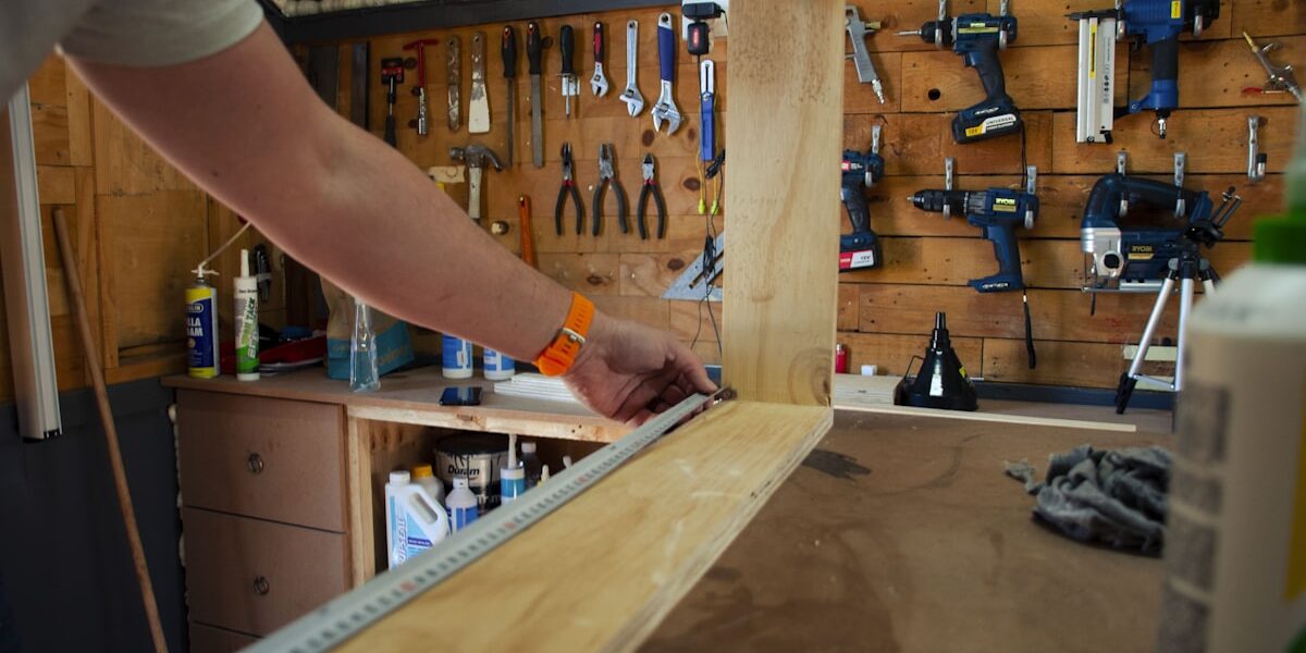 Woodworker measuring and assembling a half-lap joint frame in workshop