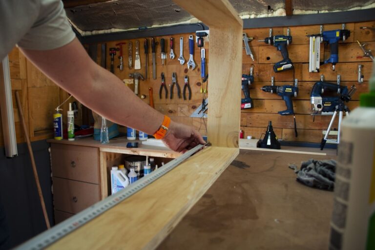 Woodworker measuring and assembling a half-lap joint frame in workshop