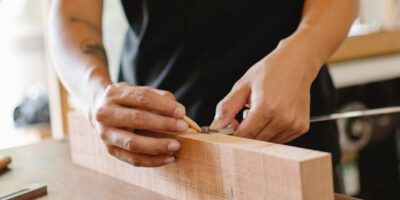 Woodworking craftsman measuring wooden plank