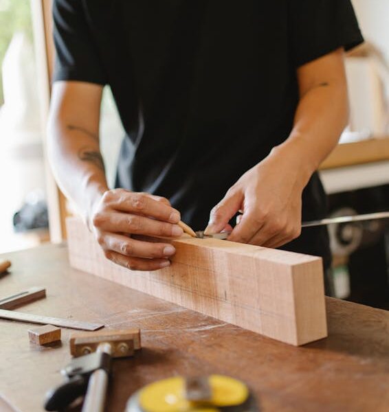 Woodworking craftsman measuring wooden plank